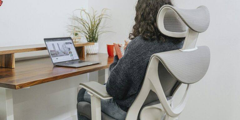 gamer sitting in ergonomic chair at desk