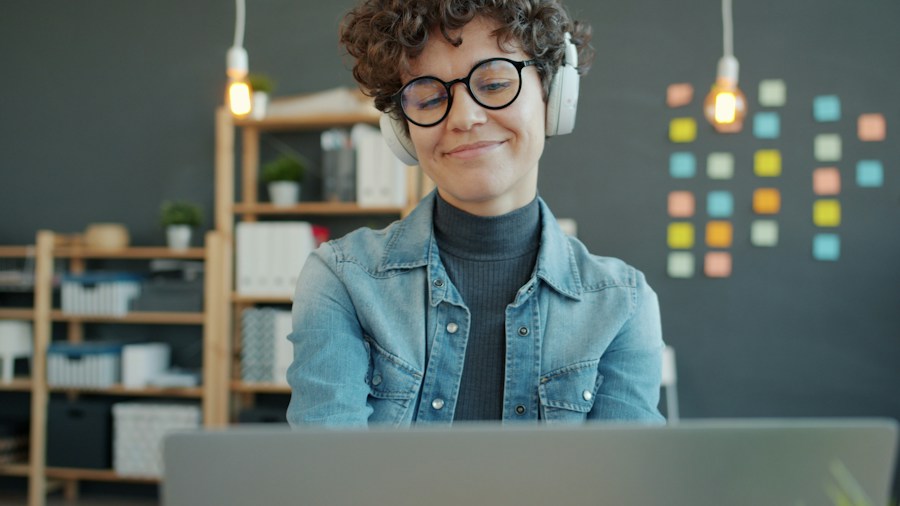 Sony Brings Back Popular XM4C Headphones: What Shoppers Need to Know 1 person wearing headphones desk work